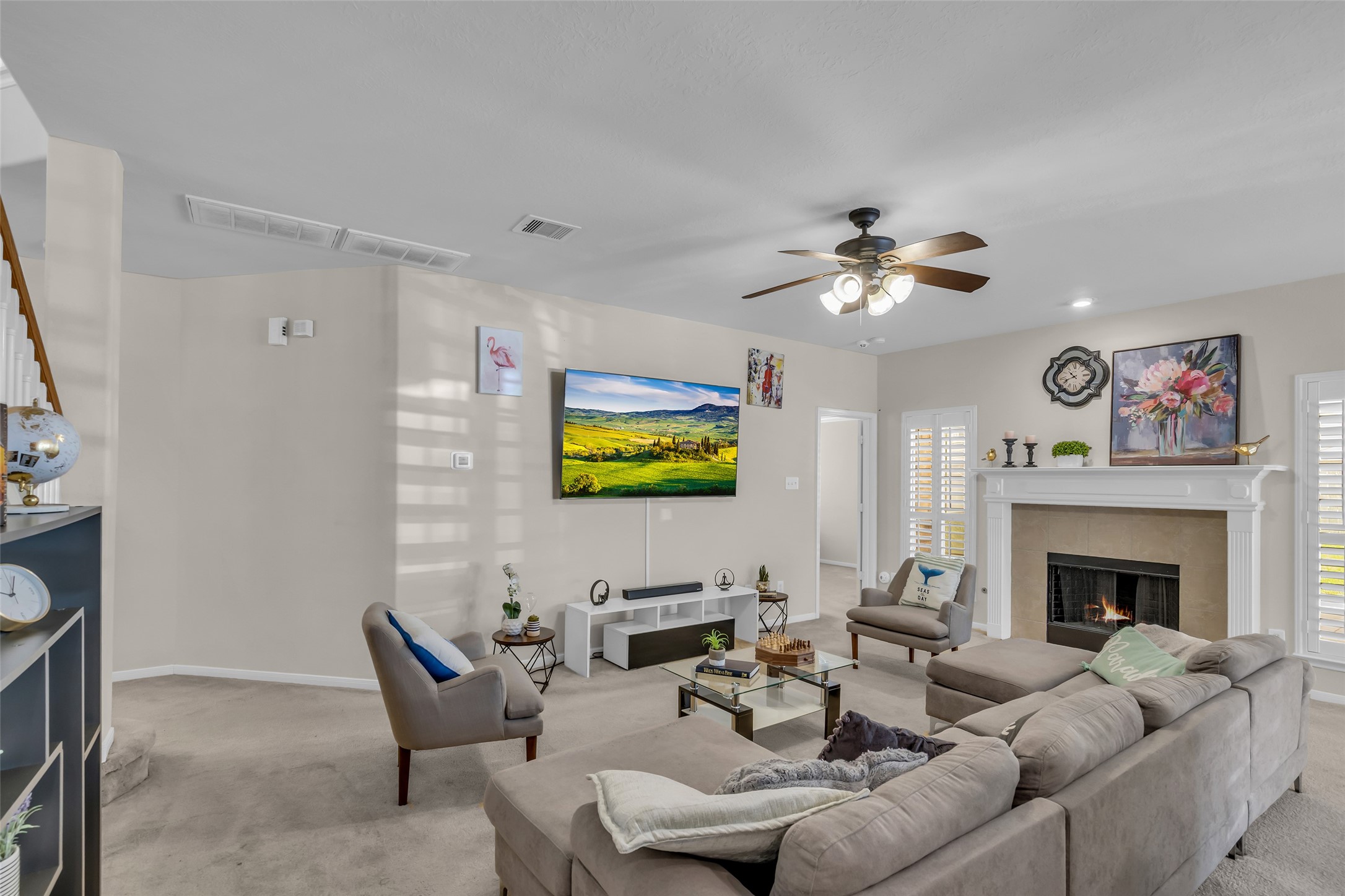 6807 Chapelfield Lane Houston, TX 77049 - Photo 20 of 42 a living room with furniture a fireplace and a flat screen tv