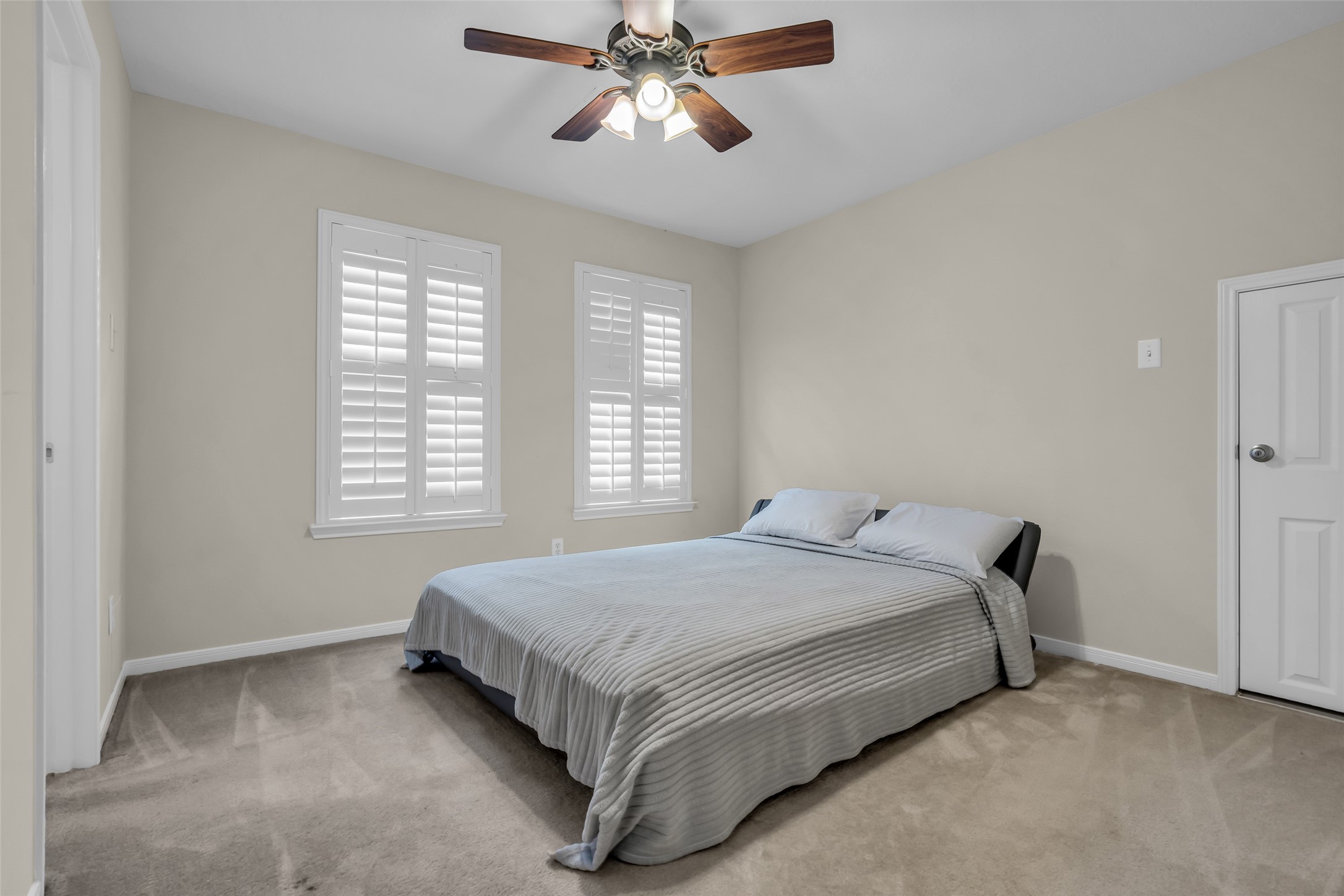 6807 Chapelfield Lane Houston, TX 77049 - Photo 27 of 42 a bed sitting in a bedroom next to a window