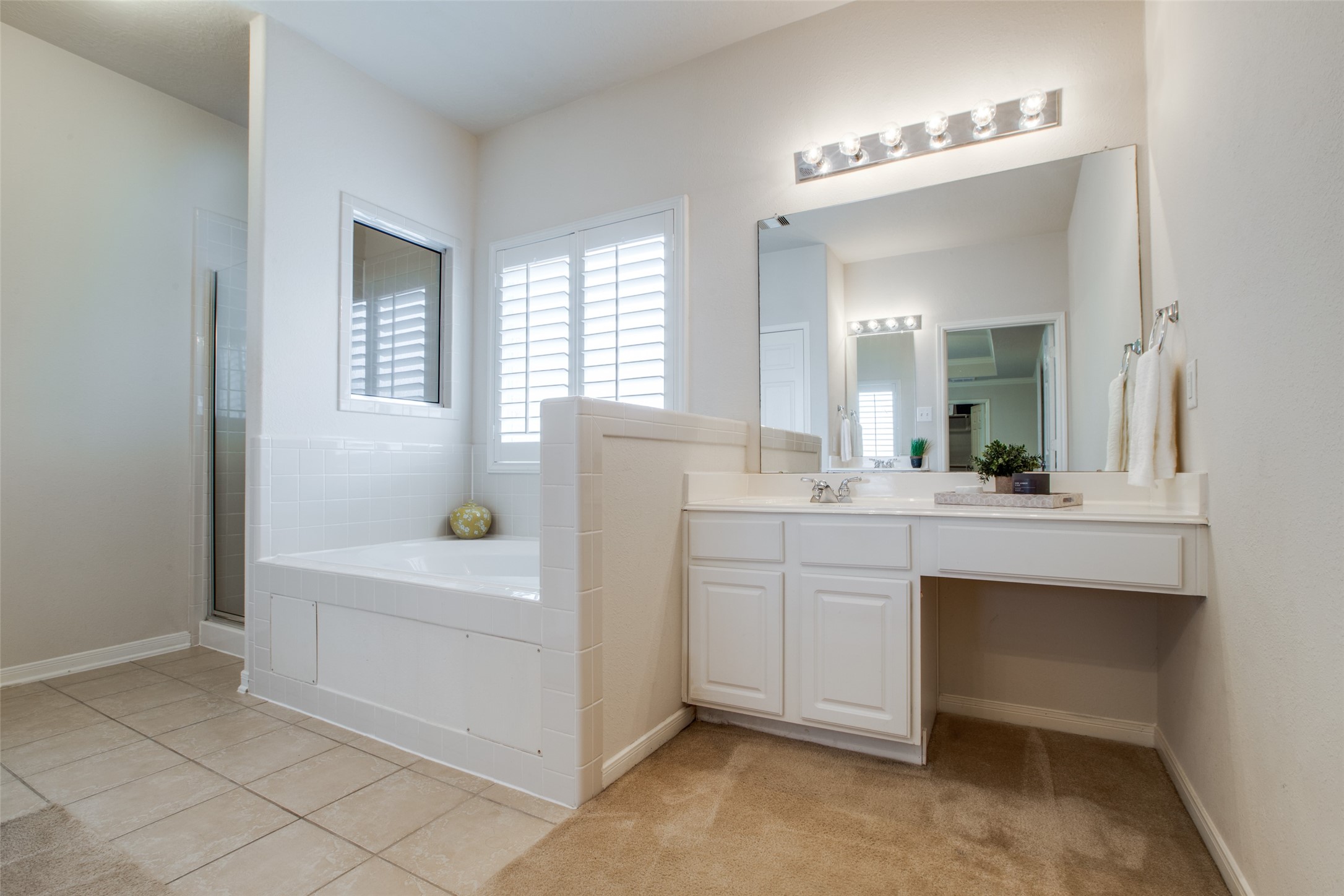 6807 Chapelfield Lane Houston, TX 77049 - Photo 28 of 42 a bathroom with a sink vanity tub and a mirror