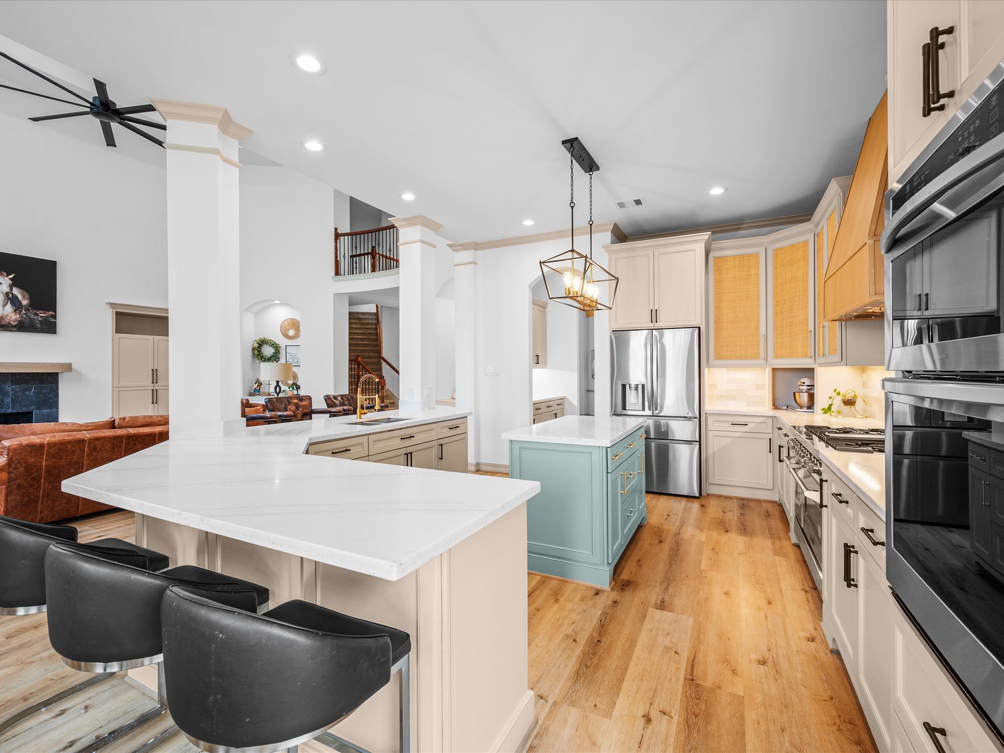 11410 Carson Field Lane Cypress, TX 77433 - Photo 12 of 47 Oversized quartz countertop island kitchen with custom real wood soft closing cabinetry and stylish lighting.