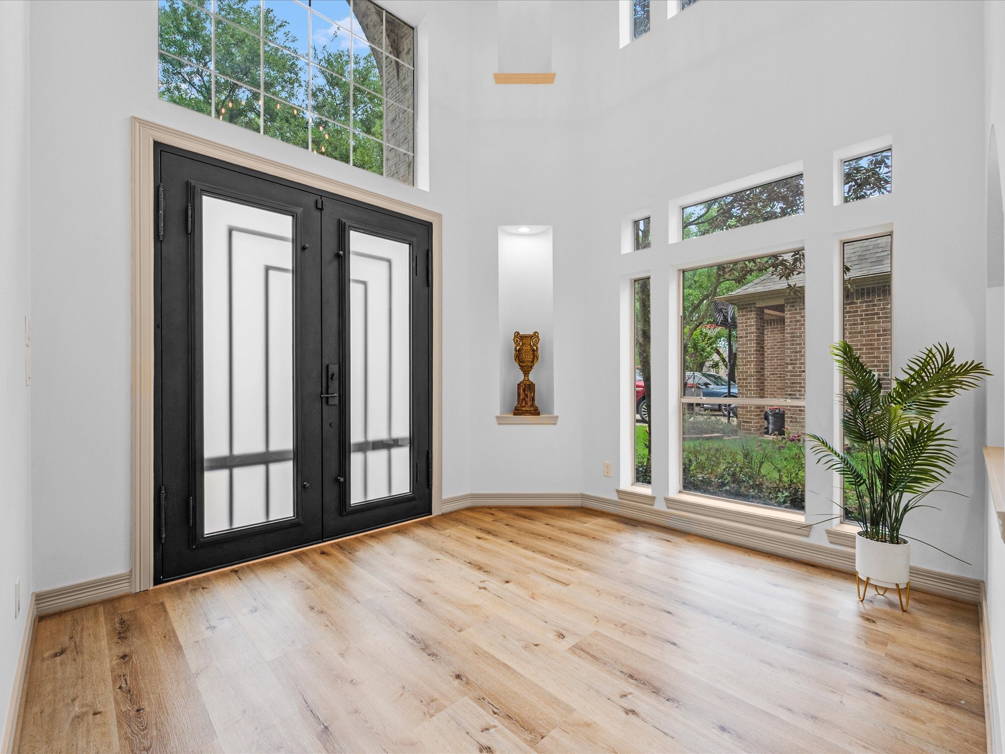 11410 Carson Field Lane Cypress, TX 77433 - Photo 2 of 47 Custom steel double doors open to soaring entry way with large windows, abundant natural light, and modern flooring.