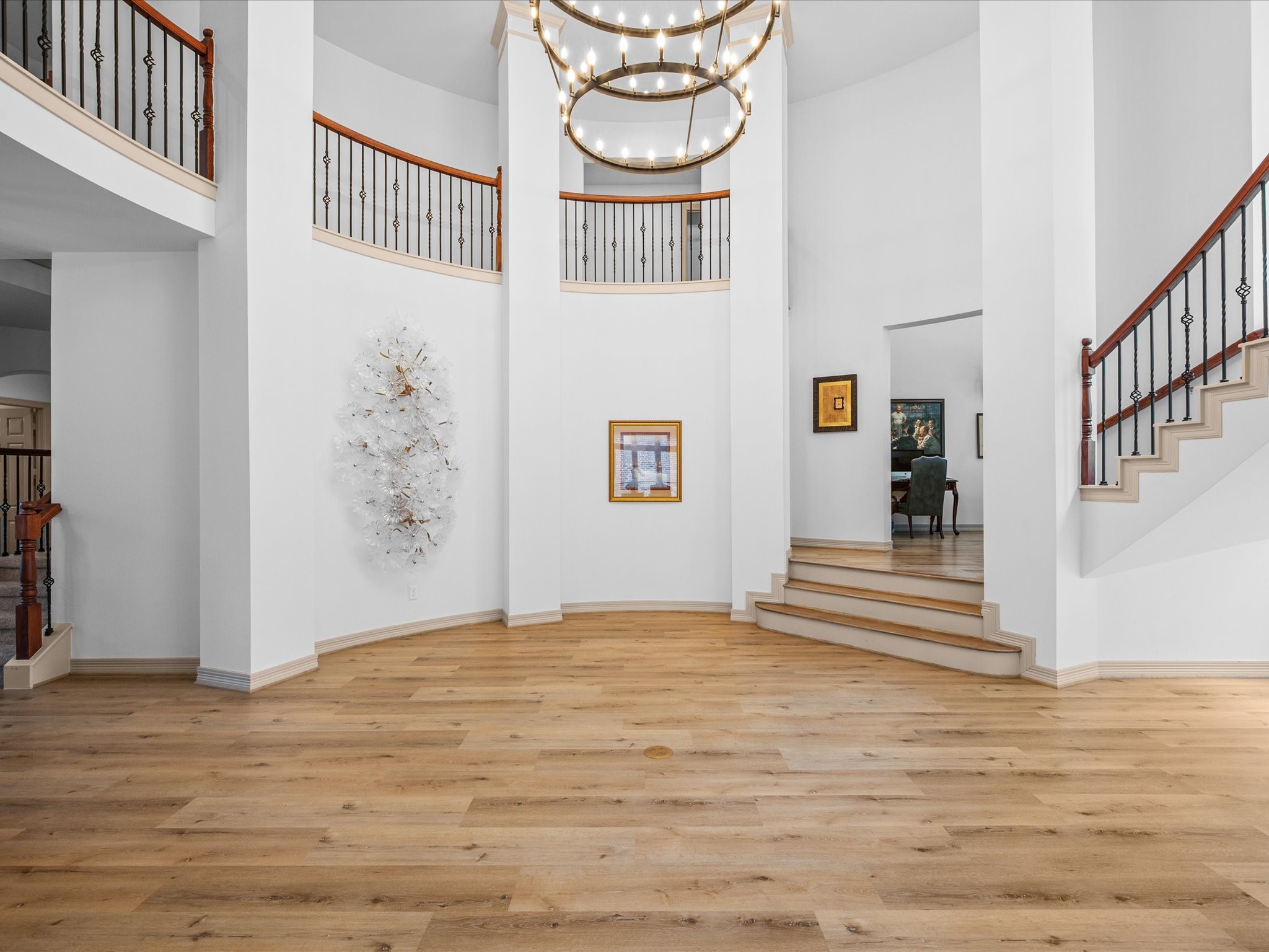 11410 Carson Field Lane Cypress, TX 77433 - Photo 27 of 47 Grand staircase with designer details and open sightlines bright and airy living space with LVP flooring and upgraded lighting