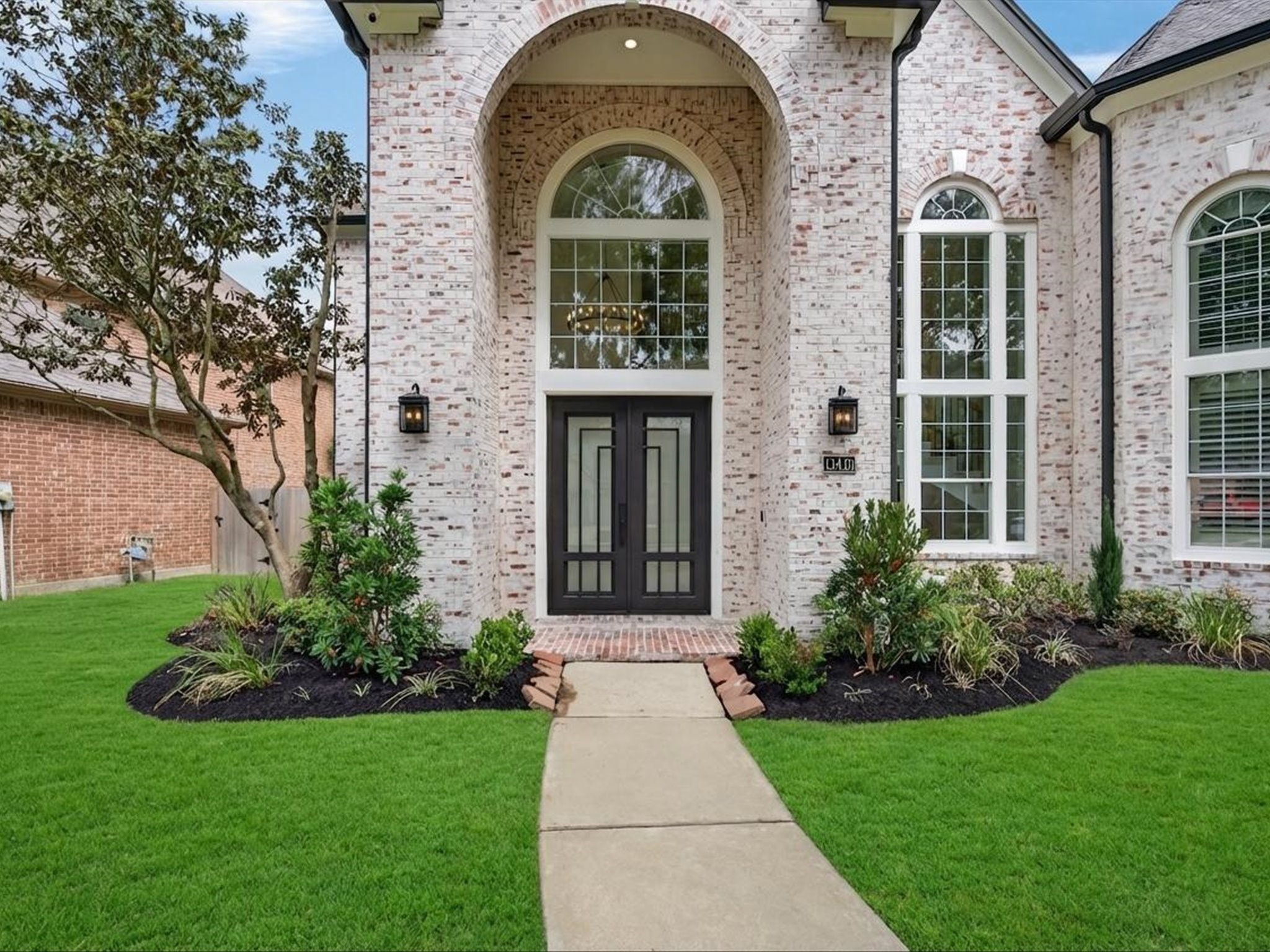 11410 Carson Field Lane Cypress, TX 77433 - Photo 40 of 47 Grand front entry with arched doorway, stone detailing, and an inviting covered entrance.