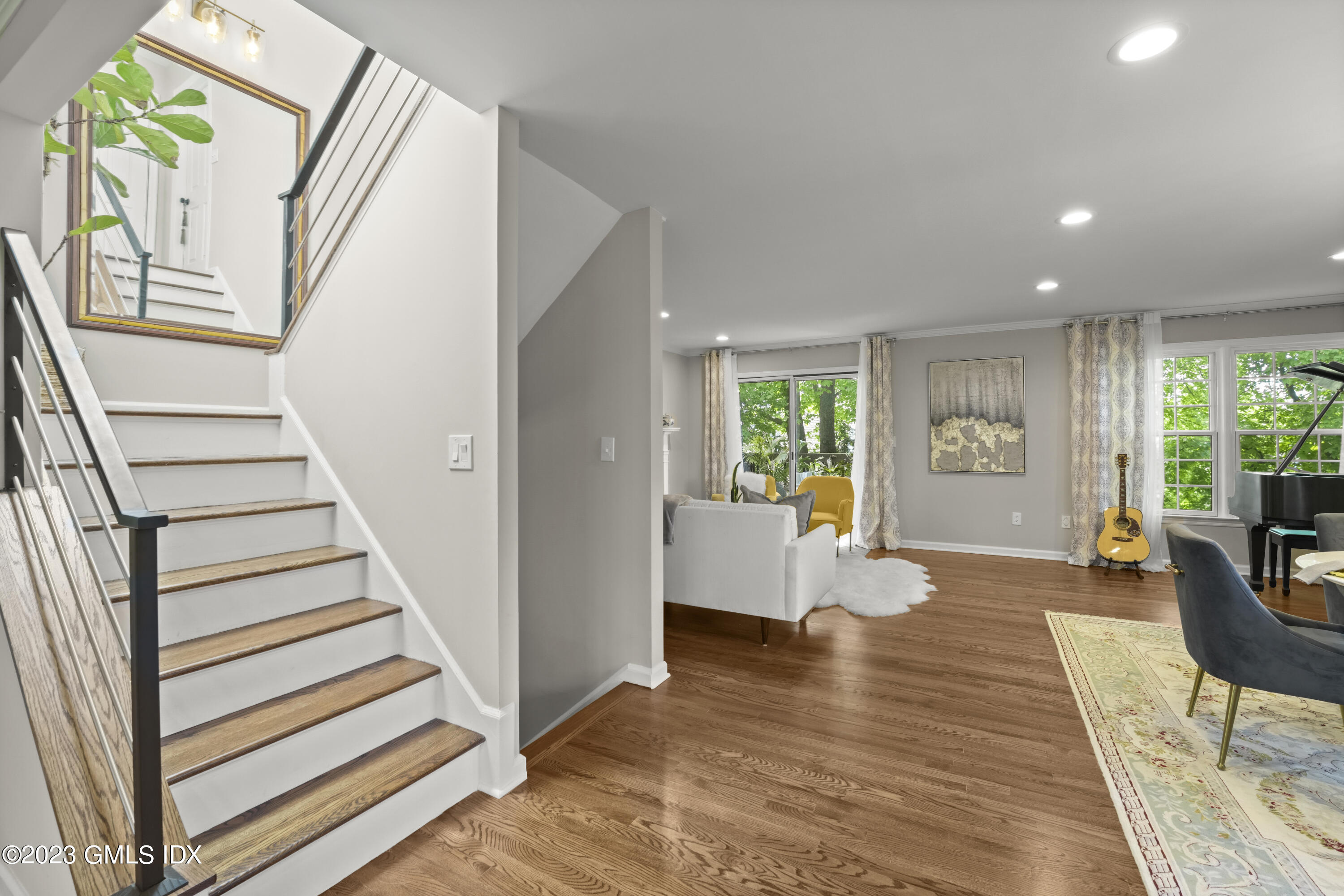 172 Field Point Road, Unit 6 Greenwich, CT 06830 - Photo 12 of 36 a view of a living room with wooden floor and windows