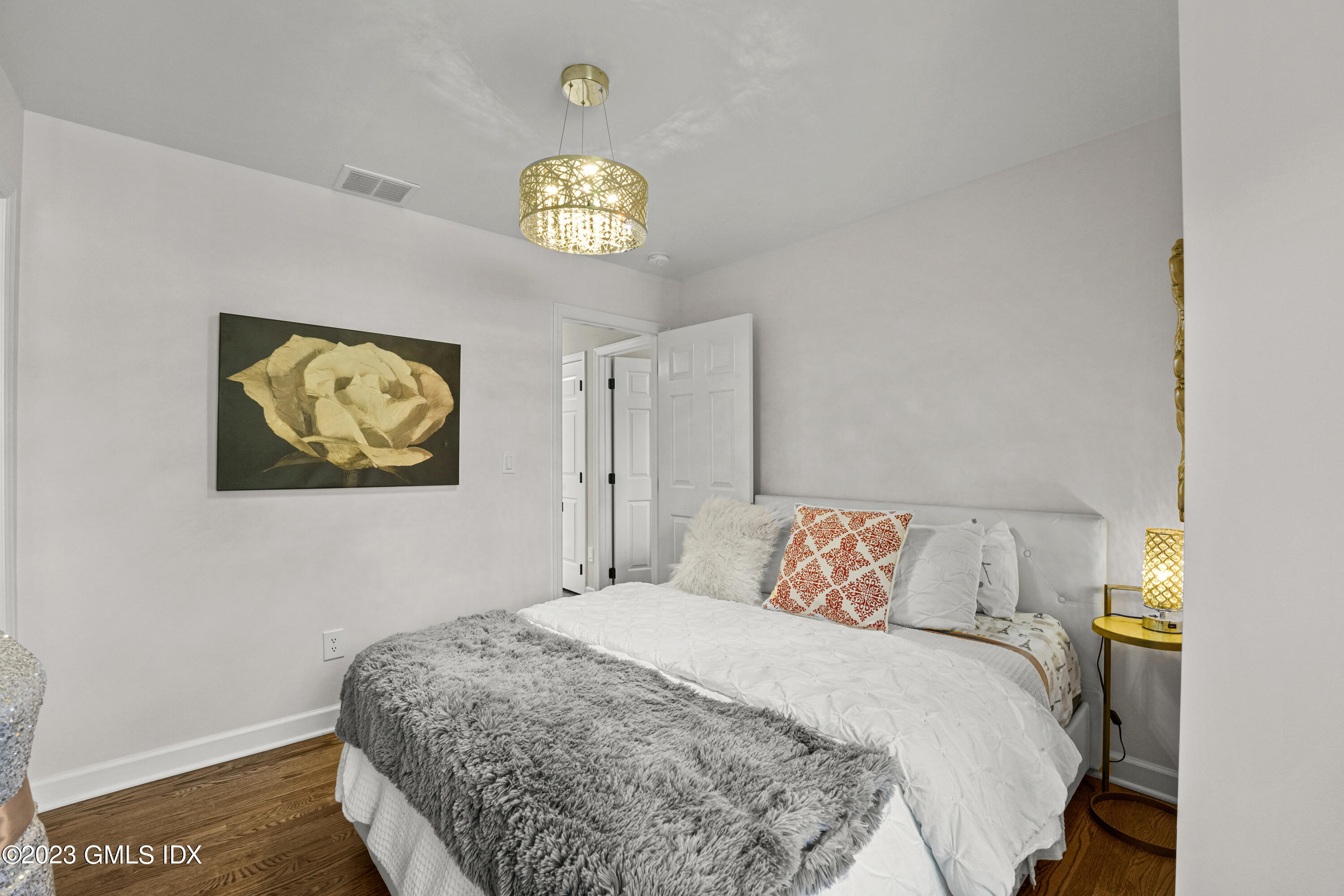 172 Field Point Road, Unit 6 Greenwich, CT 06830 - Photo 19 of 36 a bedroom with a bed and a table