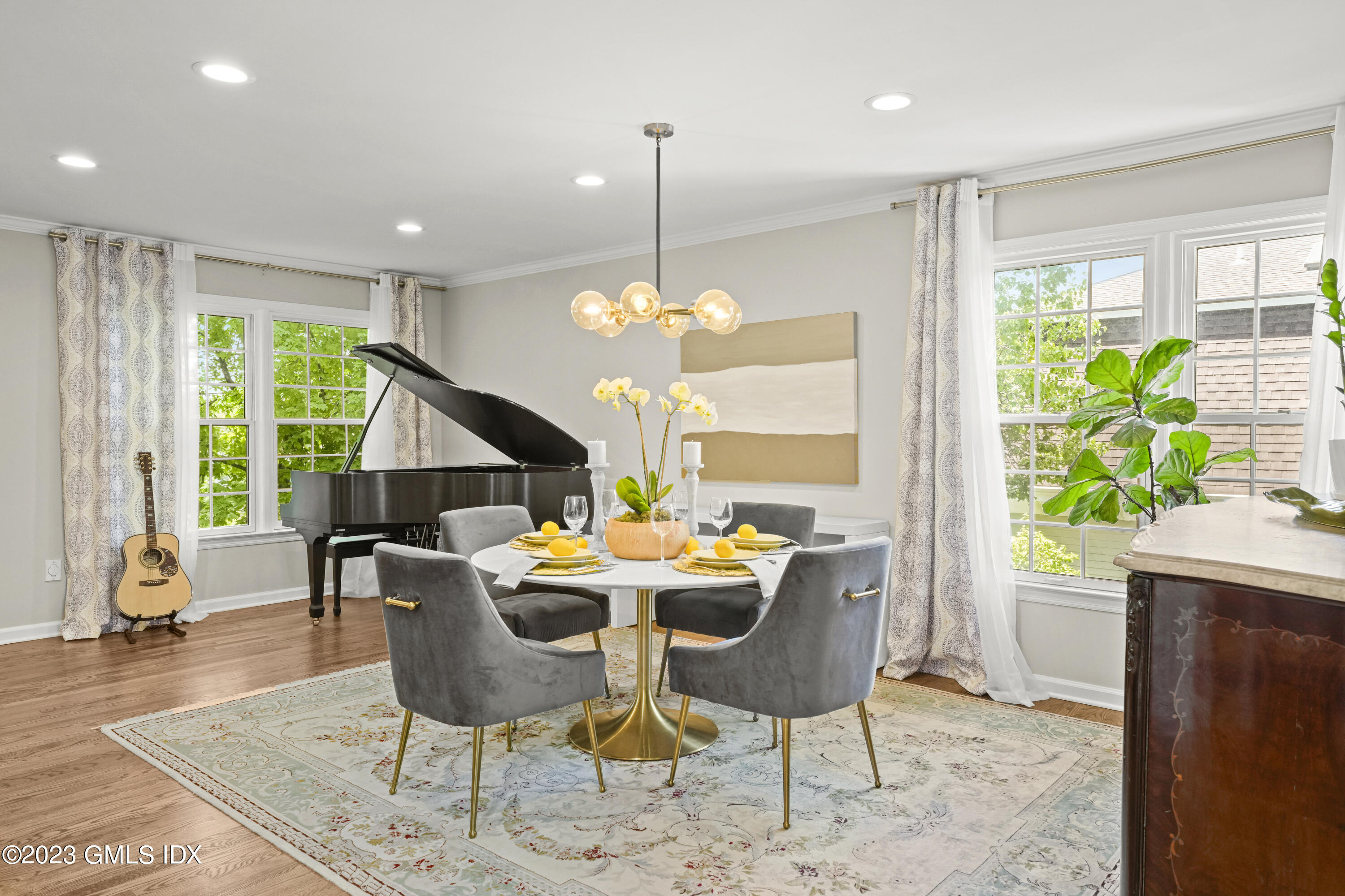 172 Field Point Road, Unit 6 Greenwich, CT 06830 - Photo 2 of 36 a dining room filled chandelier and wooden floor