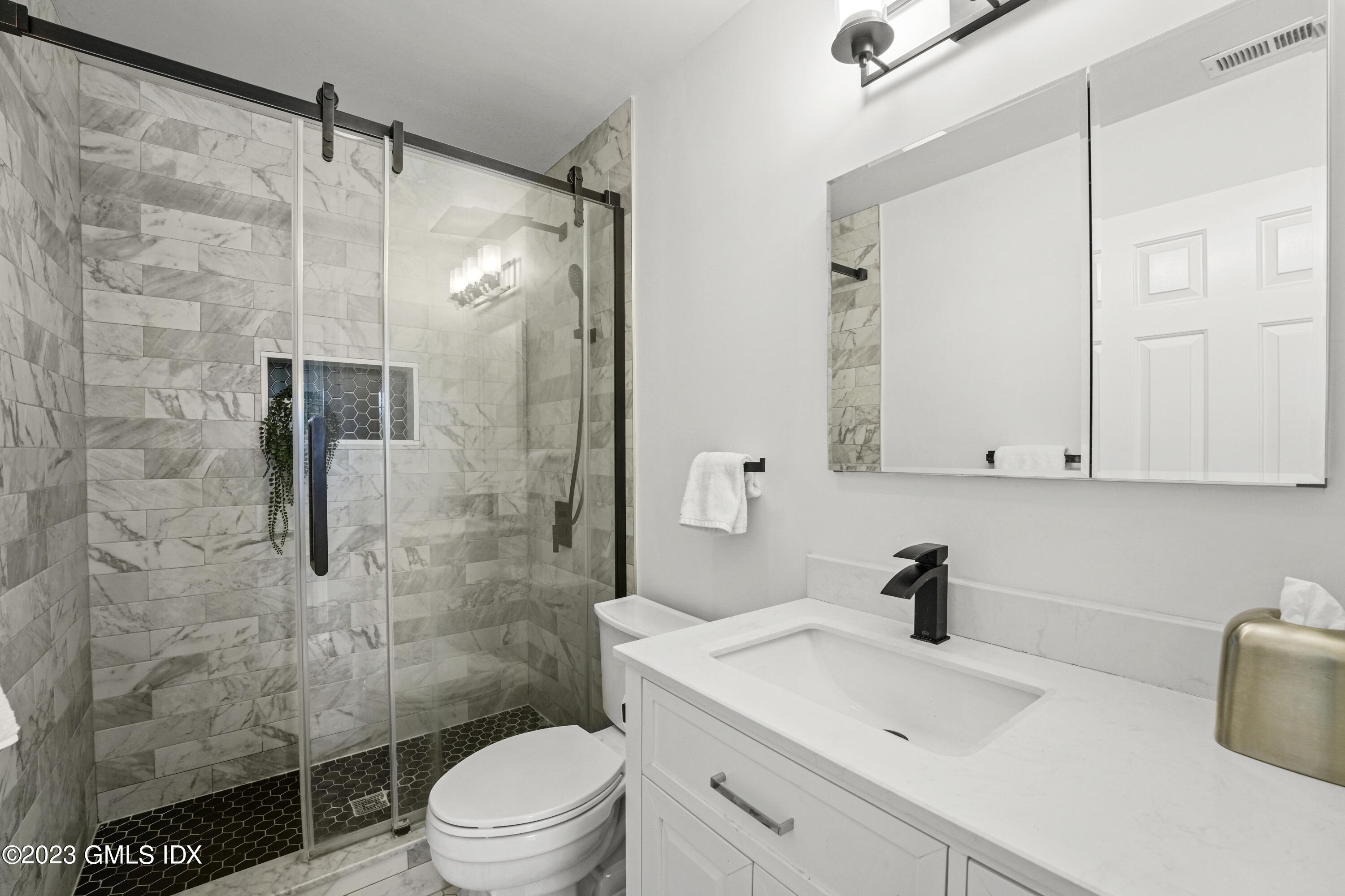 172 Field Point Road, Unit 6 Greenwich, CT 06830 - Photo 21 of 36 a bathroom with a sink toilet a mirror and shower