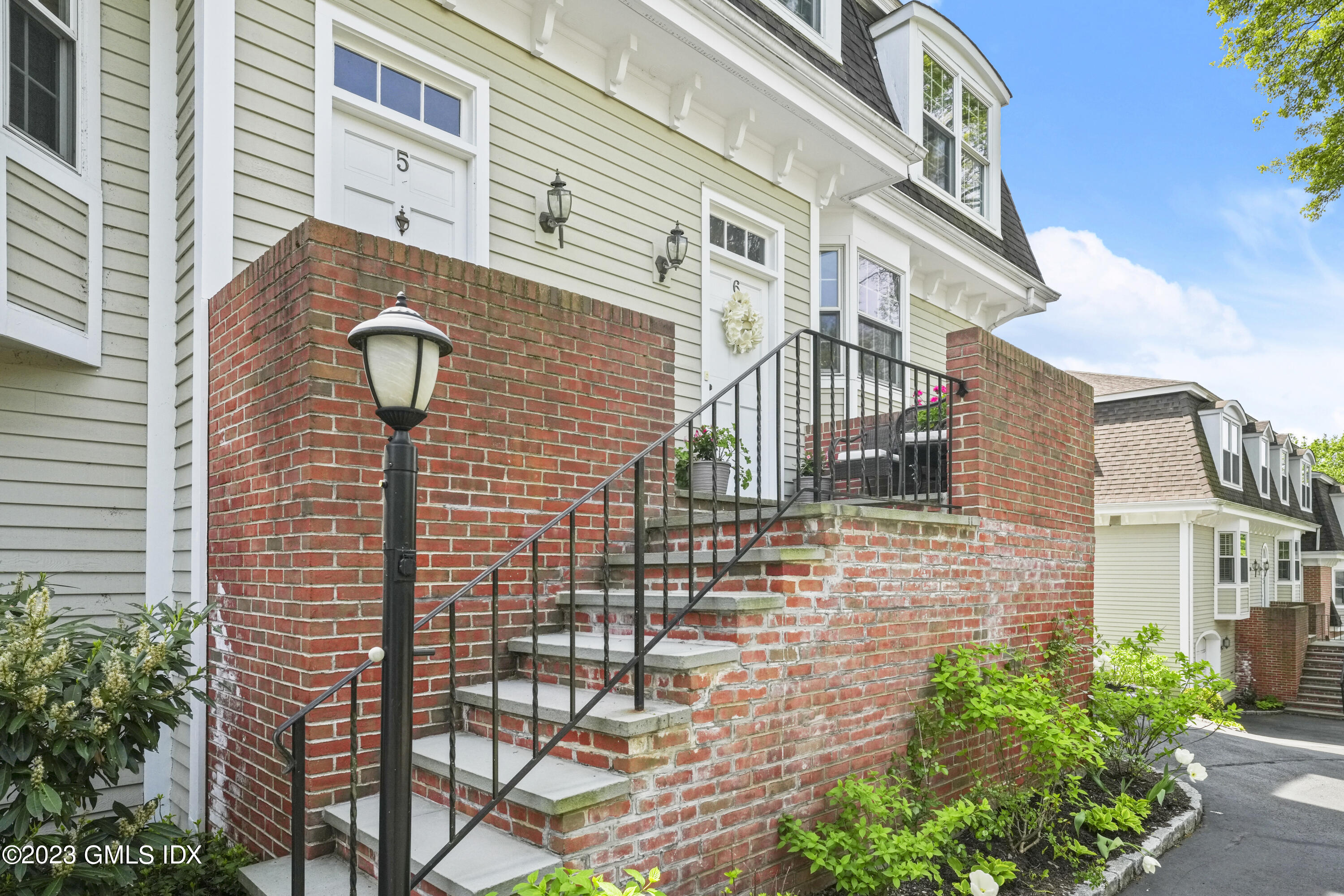 172 Field Point Road, Unit 6 Greenwich, CT 06830 - Photo 31 of 36 a view of a brick house with many windows