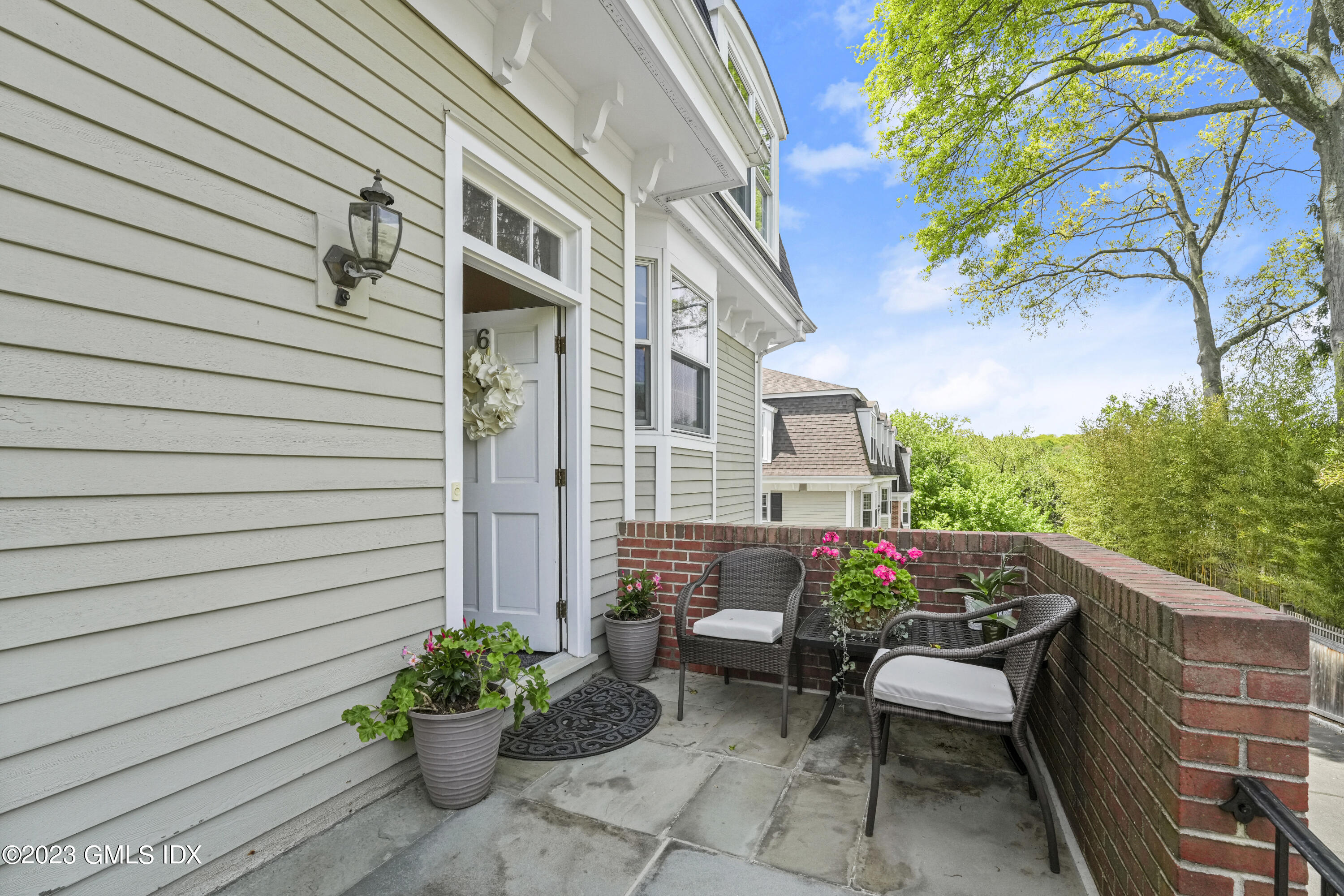 172 Field Point Road, Unit 6 Greenwich, CT 06830 - Photo 33 of 36 a patio with table and chairs and potted plants