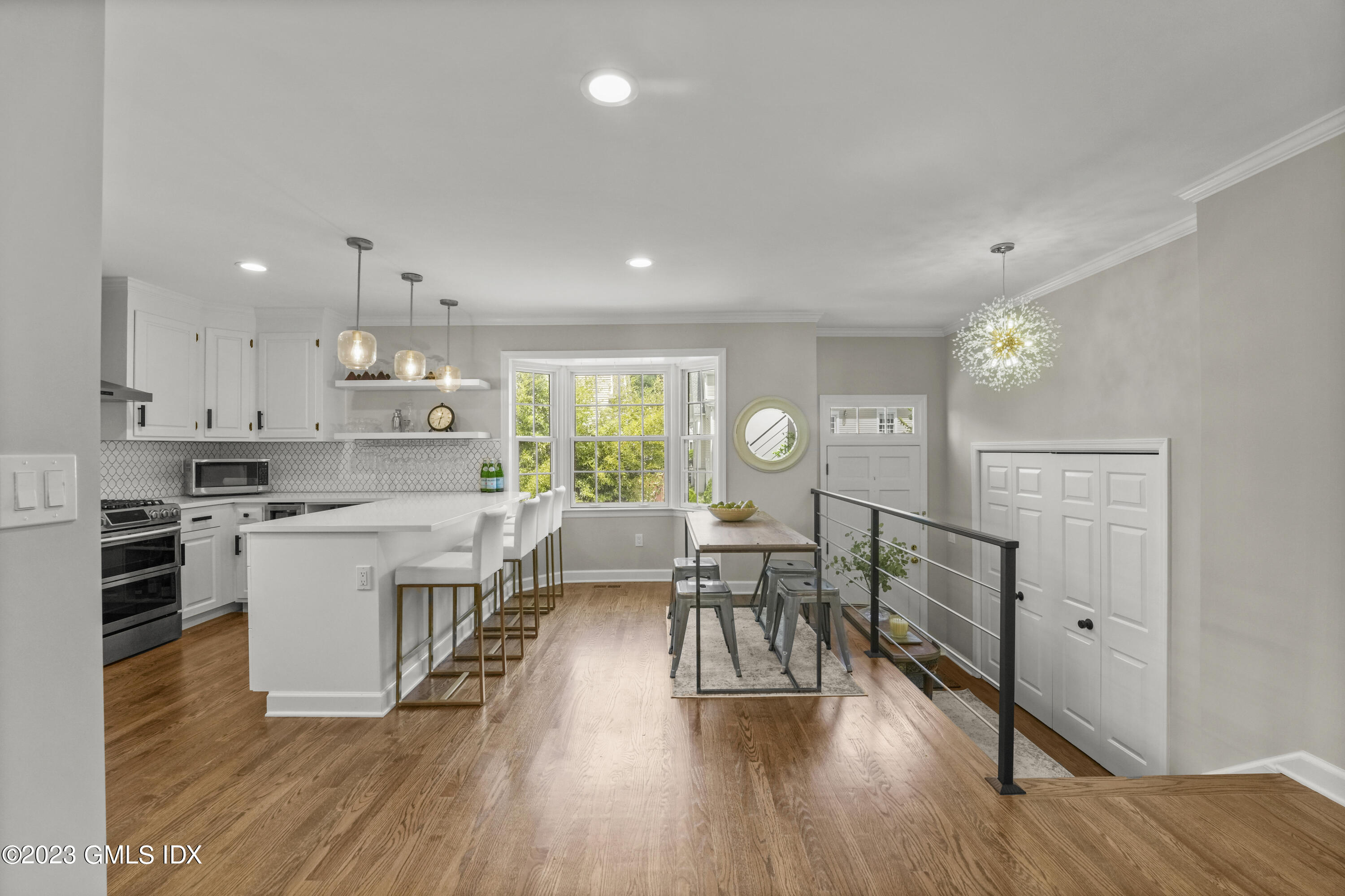 172 Field Point Road, Unit 6 Greenwich, CT 06830 - Photo 6 of 36 a large white kitchen with lots of counter space a sink appliances and dining table