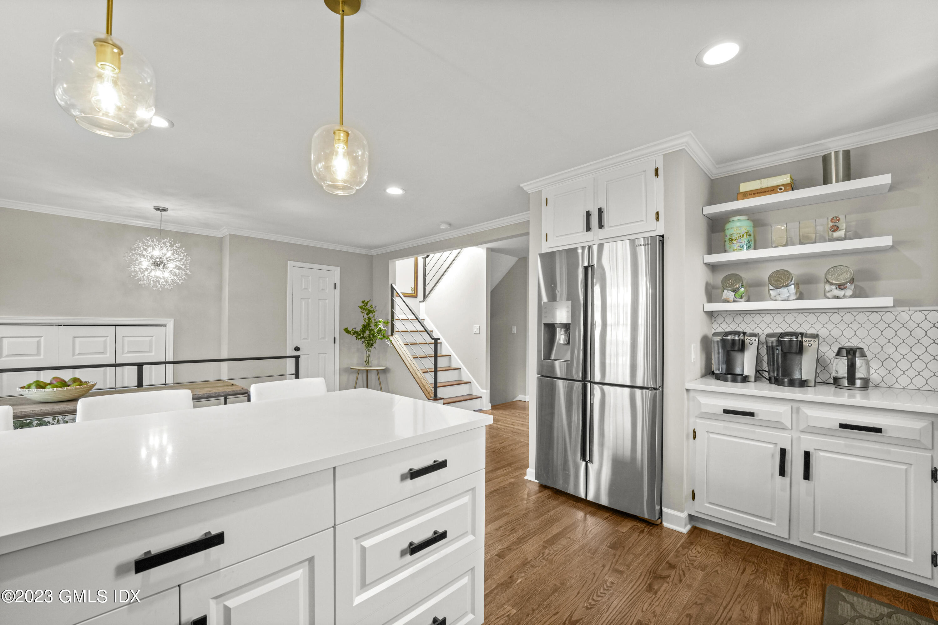 172 Field Point Road, Unit 6 Greenwich, CT 06830 - Photo 8 of 36 a kitchen with kitchen island white cabinets and stainless steel appliances