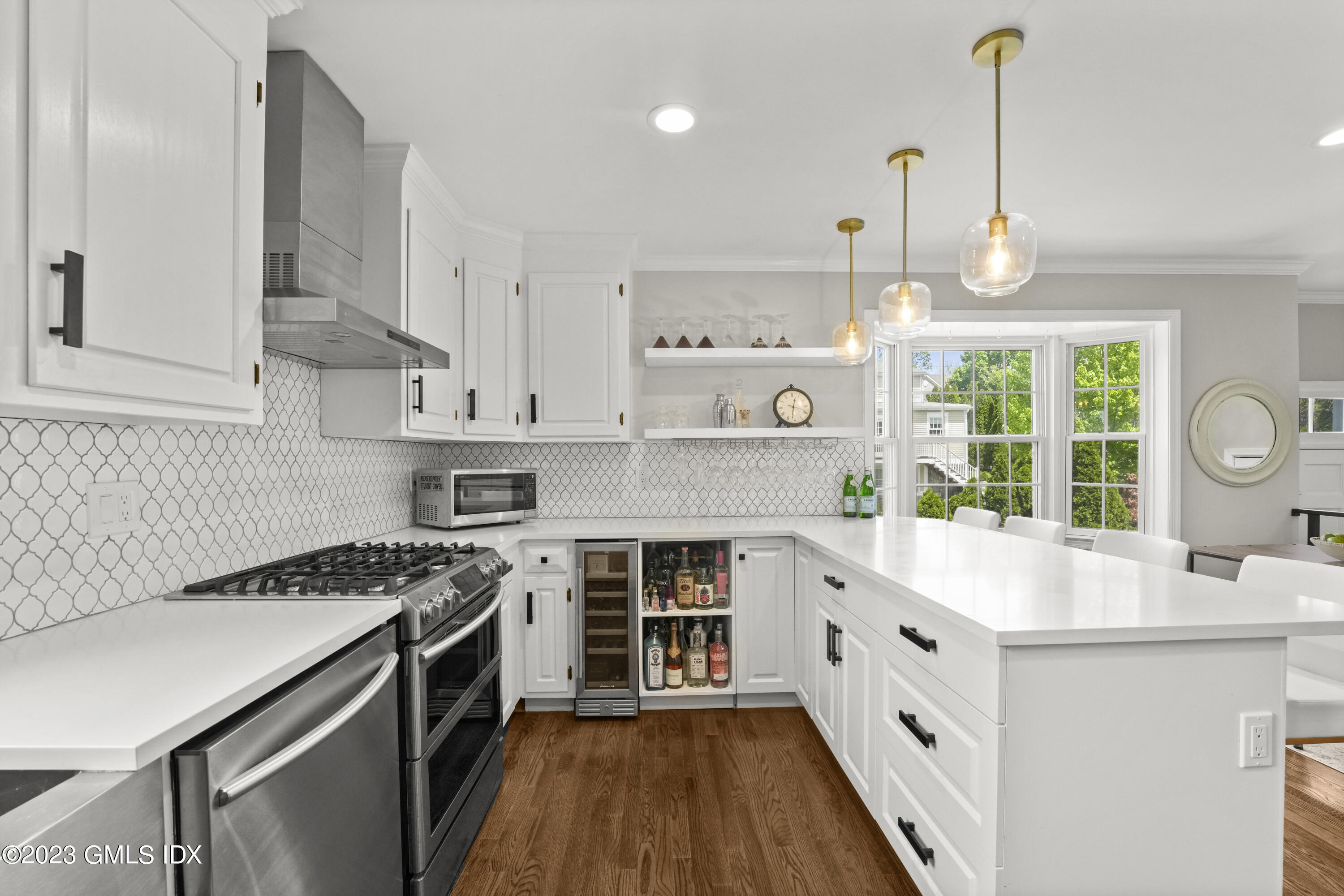 172 Field Point Road, Unit 6 Greenwich, CT 06830 - Photo 9 of 36 a kitchen with kitchen island a stove a sink a counter space and a window