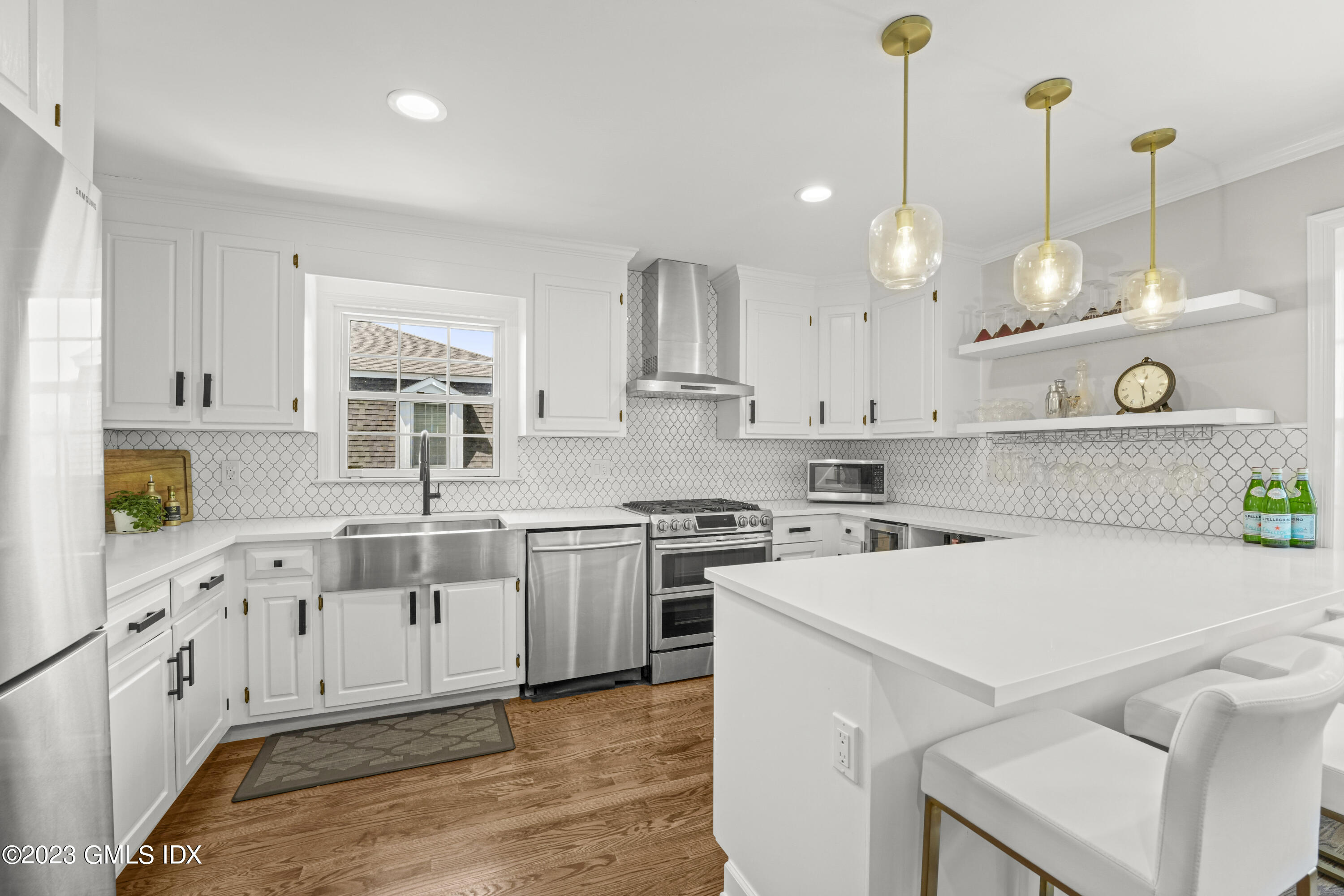 172 Field Point Road, Unit 6 Greenwich, CT 06830 - Photo 10 of 36 a kitchen with white cabinets and white appliances