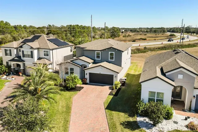 an aerial view of a house with a yard