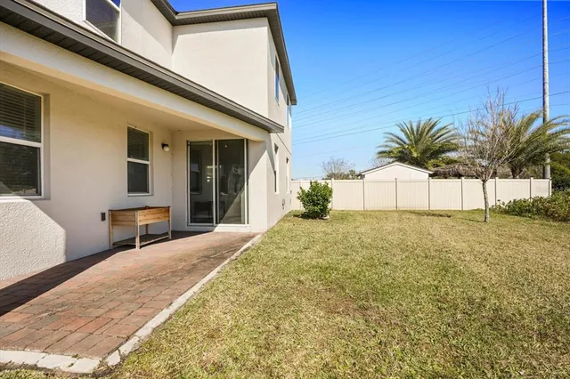 a view of a white house with a yard