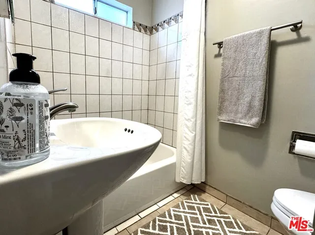 a bathroom with a bathtub and shower