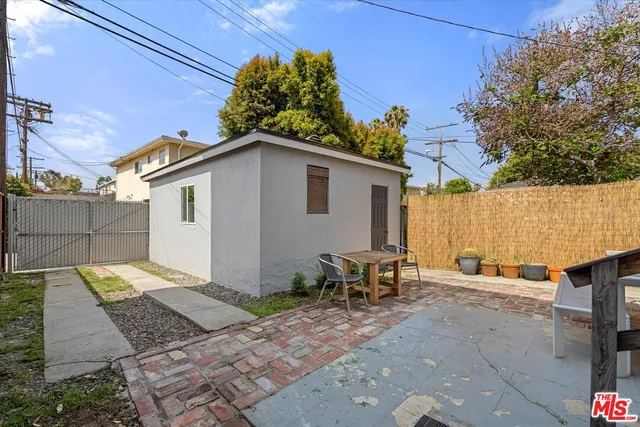 a white house with tall trees in the background