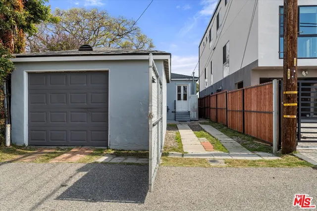 a side view of a house with wooden fence