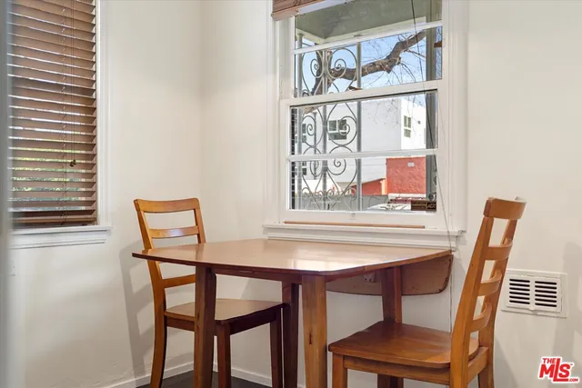 a view of a dining room with furniture and a chandelier