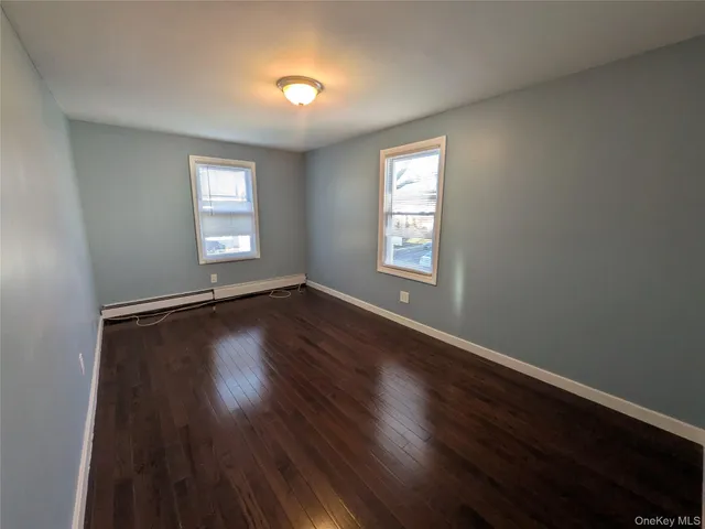 a view of a room with wooden floor and windows