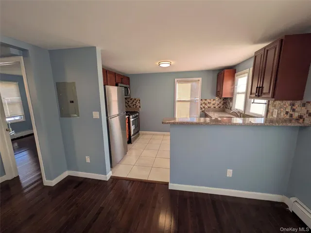 an empty room with wooden floor and a window