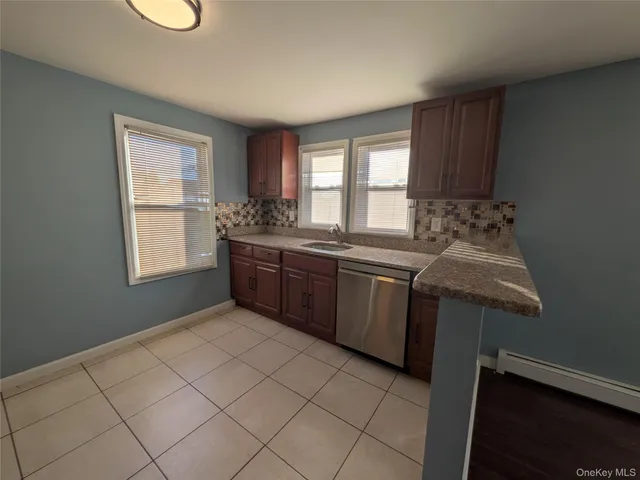 a kitchen with a sink cabinets and window