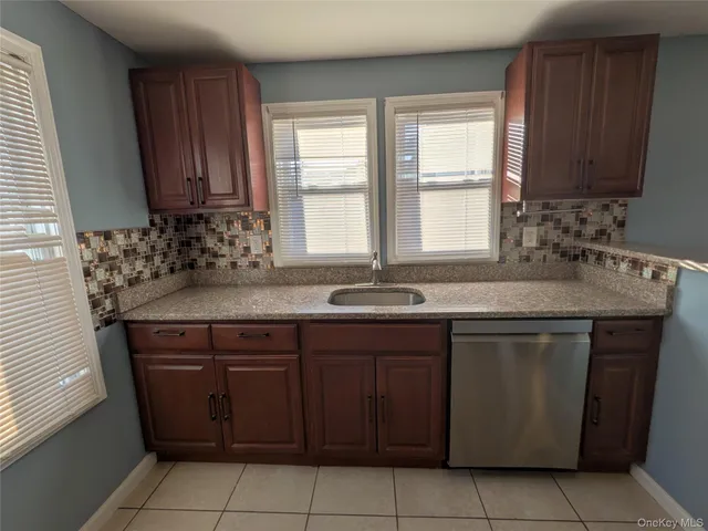 a kitchen with a sink window and cabinets
