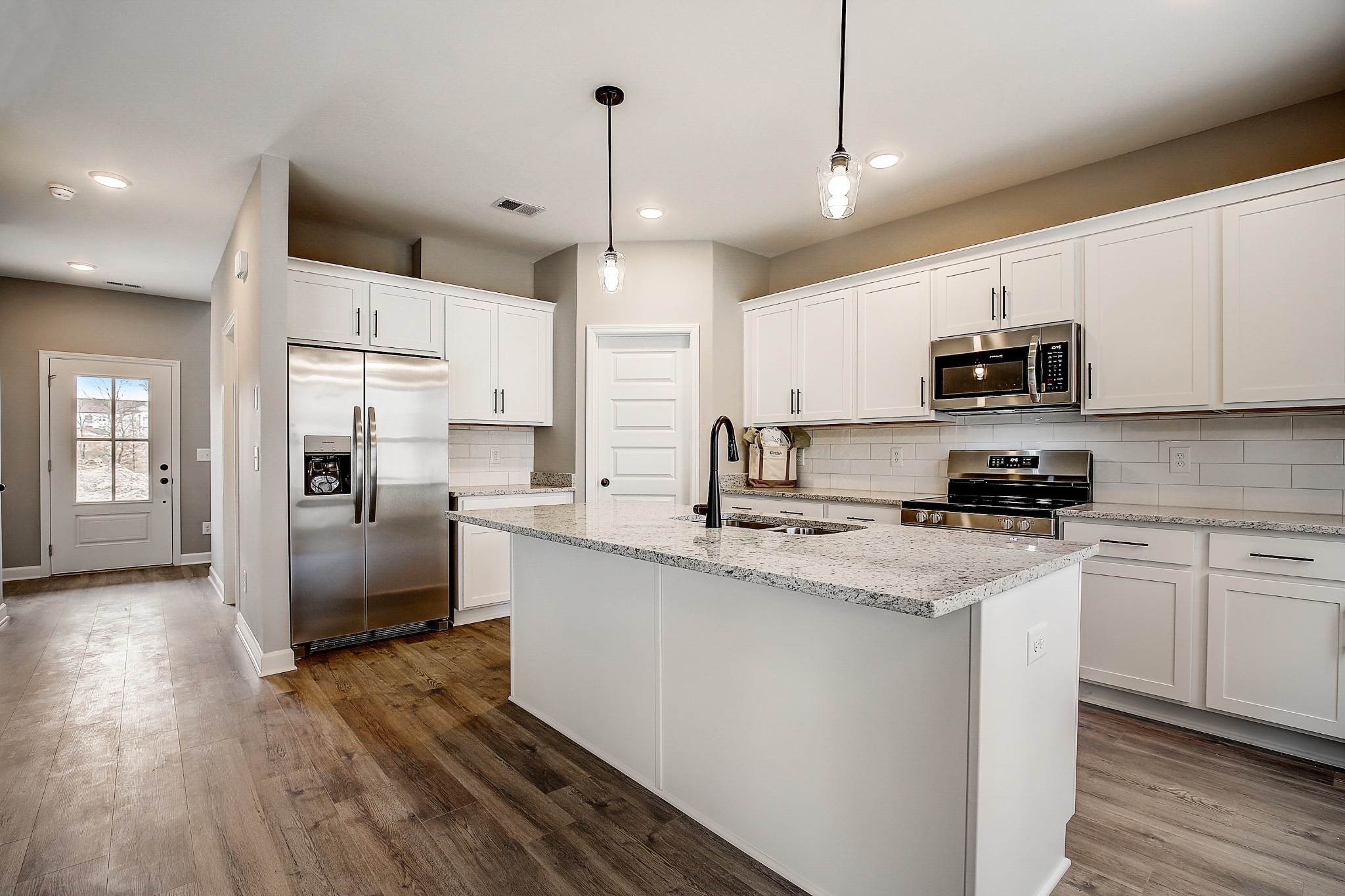 1776 Fenway Loop Antioch, TN 37013 - Photo 10 of 39 a kitchen with stainless steel appliances granite countertop a refrigerator a stove a sink and a microwave