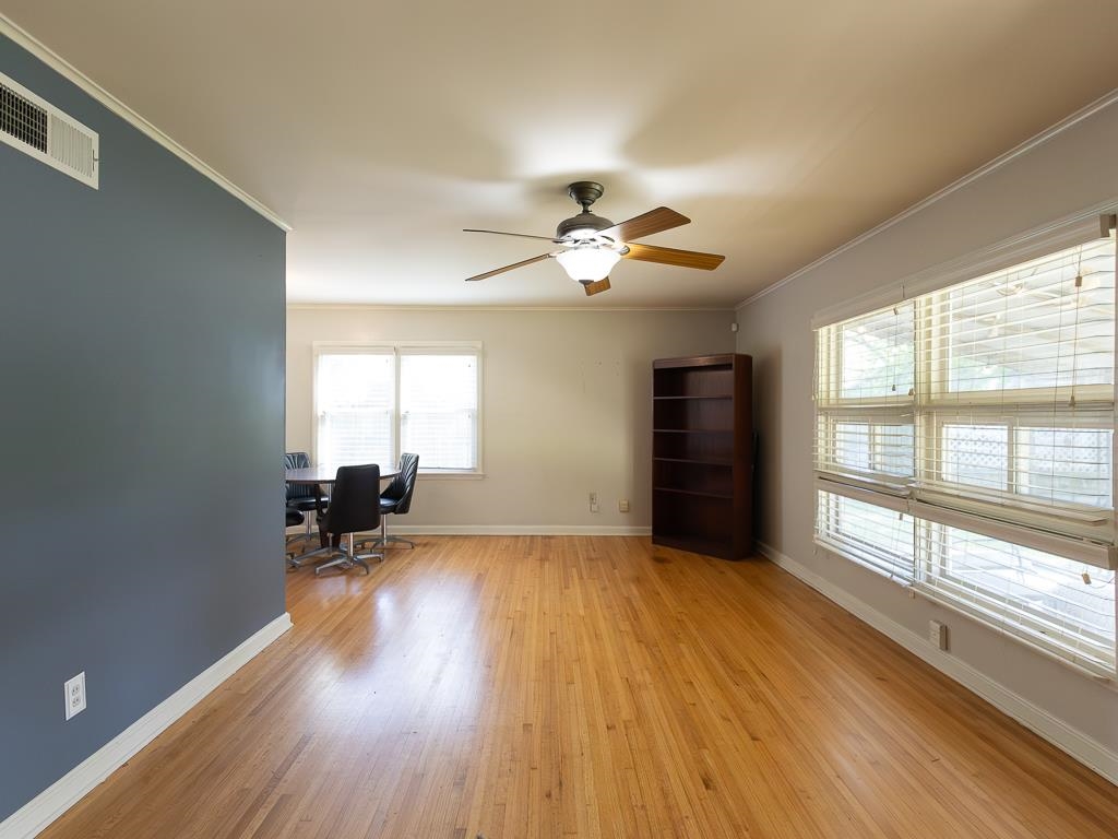 1089 Ivy Road Memphis, TN 38117 - Photo 15 of 32 a view of an empty room with a window and wooden floor