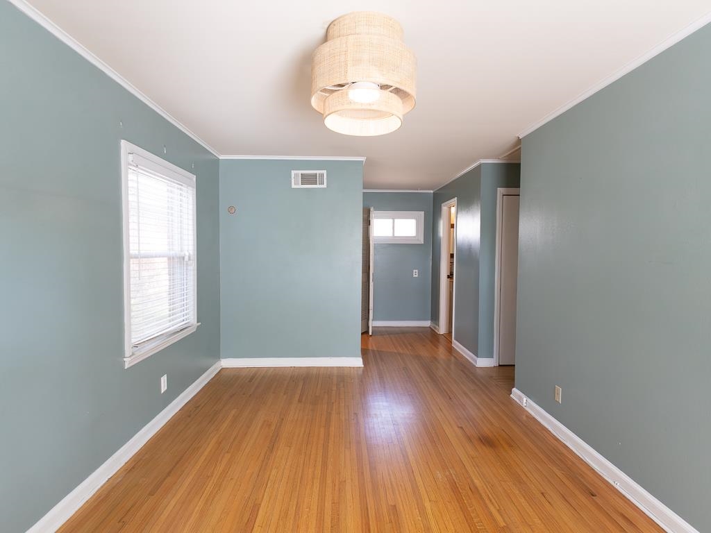 1089 Ivy Road Memphis, TN 38117 - Photo 26 of 32 an empty room with wooden floor and windows