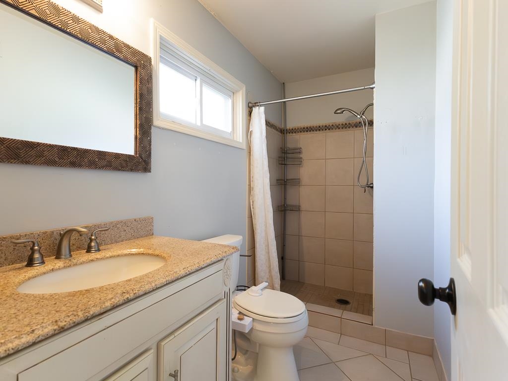 1089 Ivy Road Memphis, TN 38117 - Photo 28 of 32 a bathroom with a granite countertop sink toilet and shower