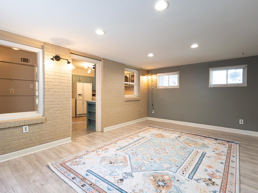 1089 Ivy Road Memphis, TN 38117 - Photo 6 of 32 a view of a big room with wooden floor and windows