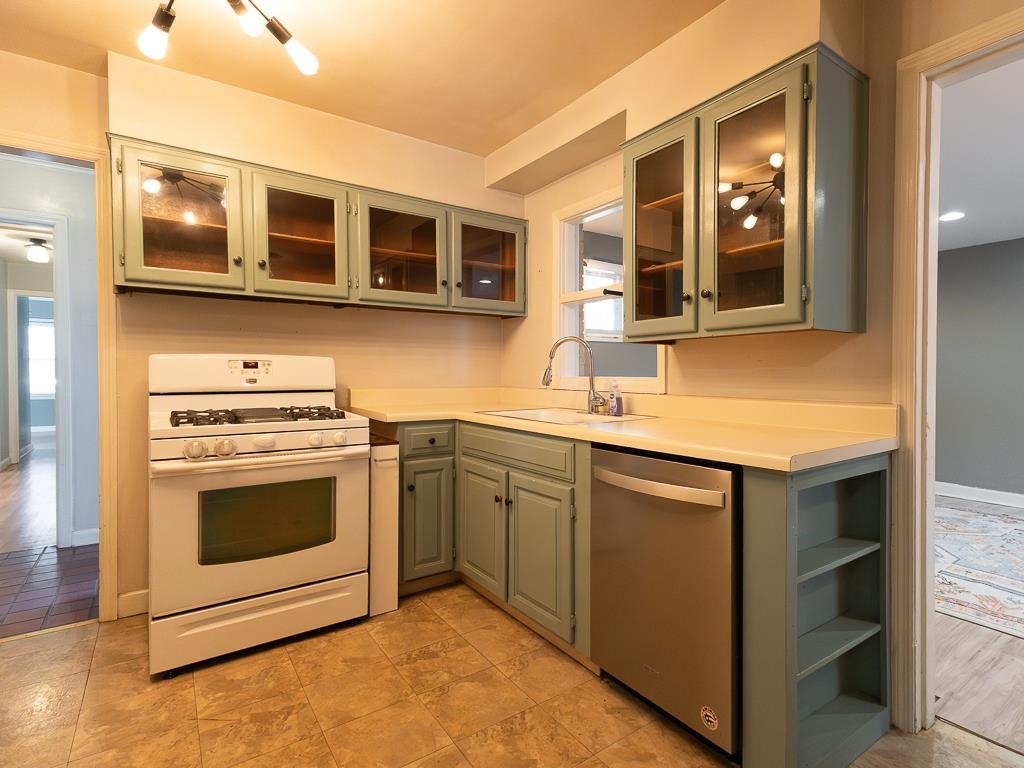 1089 Ivy Road Memphis, TN 38117 - Photo 10 of 32 a kitchen with stainless steel appliances granite countertop a stove and a microwave