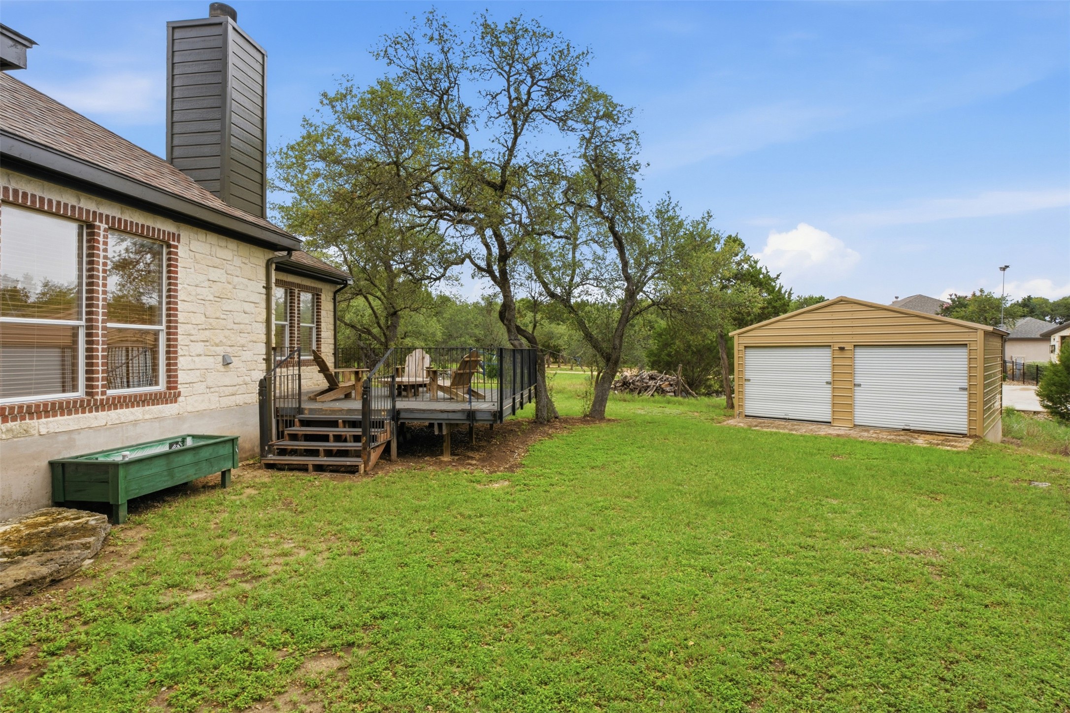 1301 County Road 262 Georgetown, TX 78633 - Photo 37 of 39 Expansive green lawn with a two-car detached garage