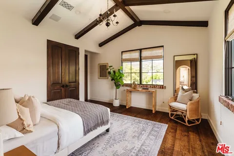 a bedroom with furniture and a window