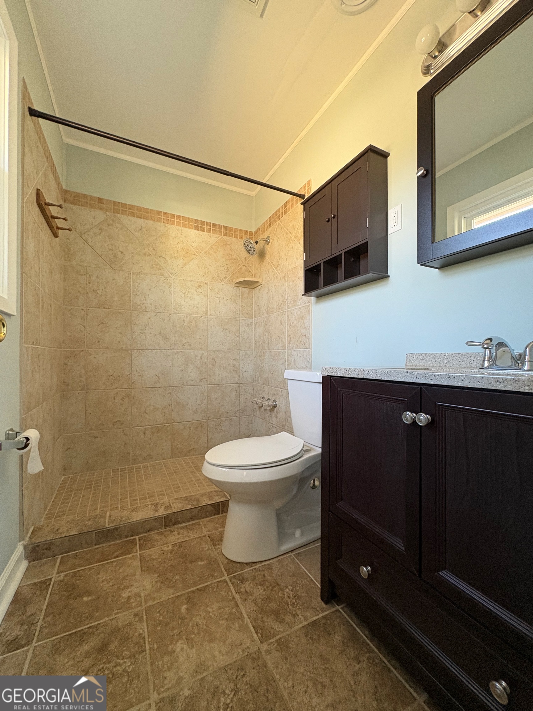 404 Magnolia Street Fort Valley, GA 31030 - Photo 15 of 21 a bathroom with a toilet a sink and shower