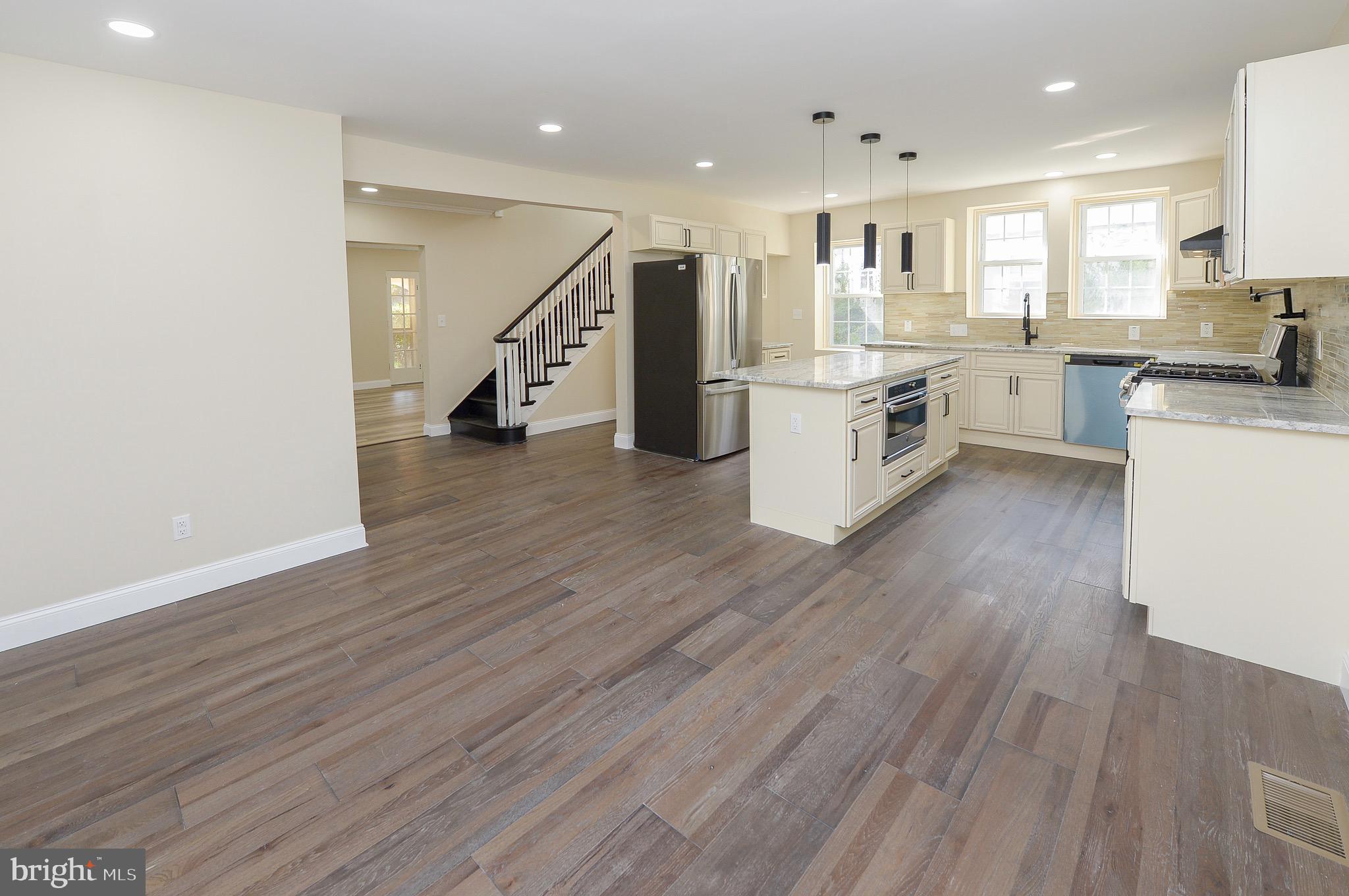 537 Church Road Elkins Park, PA 19027 - Photo 13 of 39 a kitchen with stainless steel appliances refrigerator wooden floor and a sink