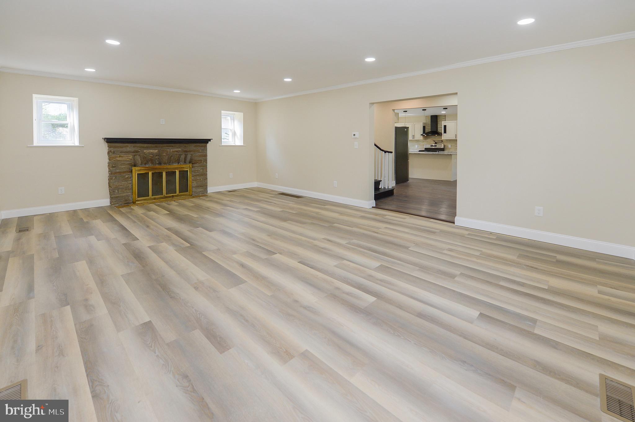 537 Church Road Elkins Park, PA 19027 - Photo 16 of 39 an empty room with wooden floor fireplace and windows