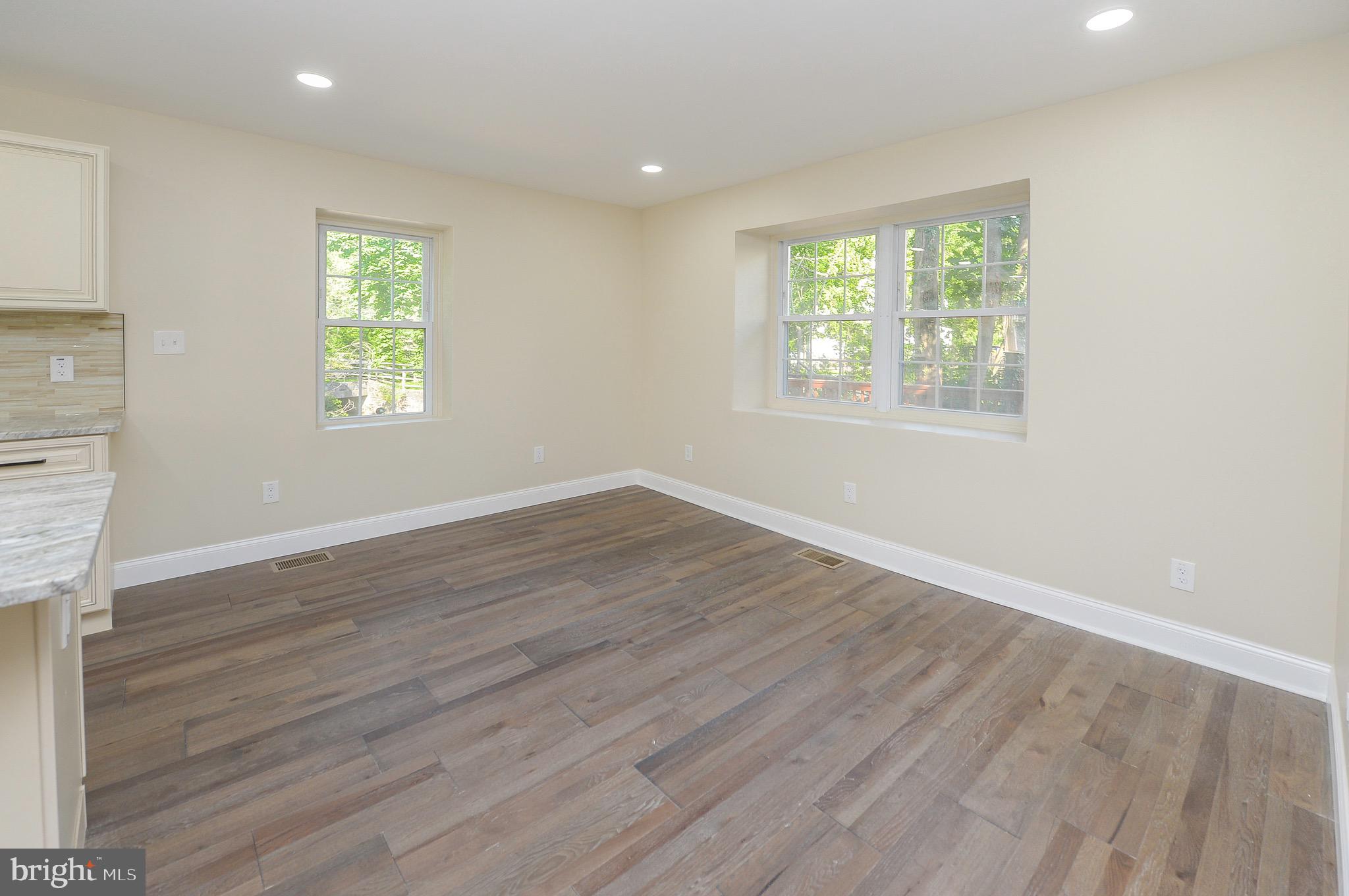 537 Church Road Elkins Park, PA 19027 - Photo 17 of 39 an empty room with wooden floor and windows