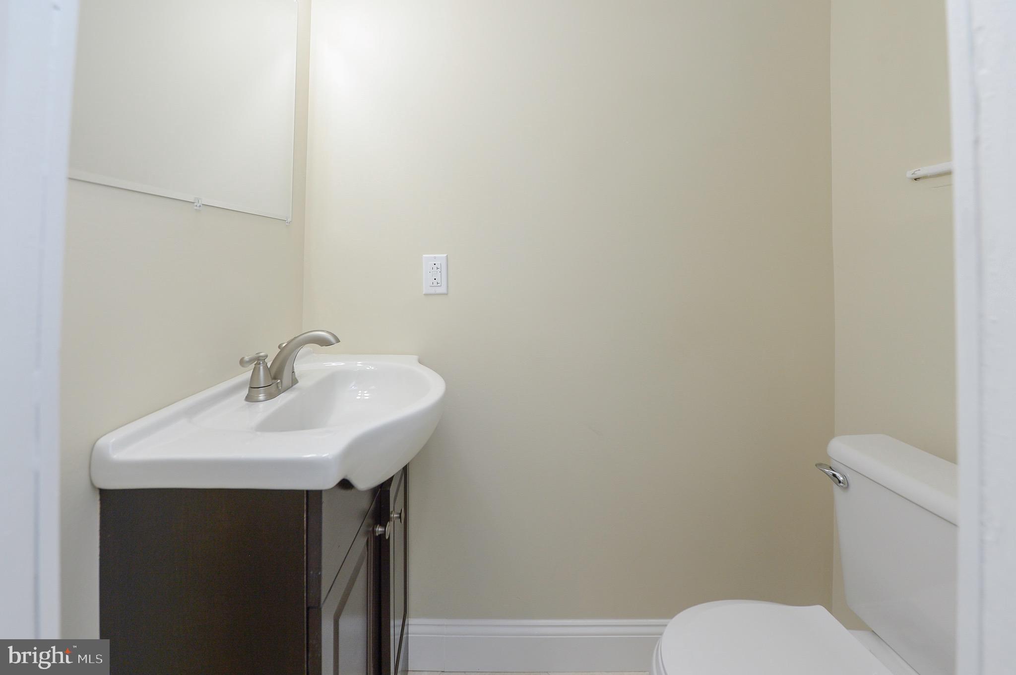 537 Church Road Elkins Park, PA 19027 - Photo 18 of 39 a bathroom with a sink toilet and a mirror