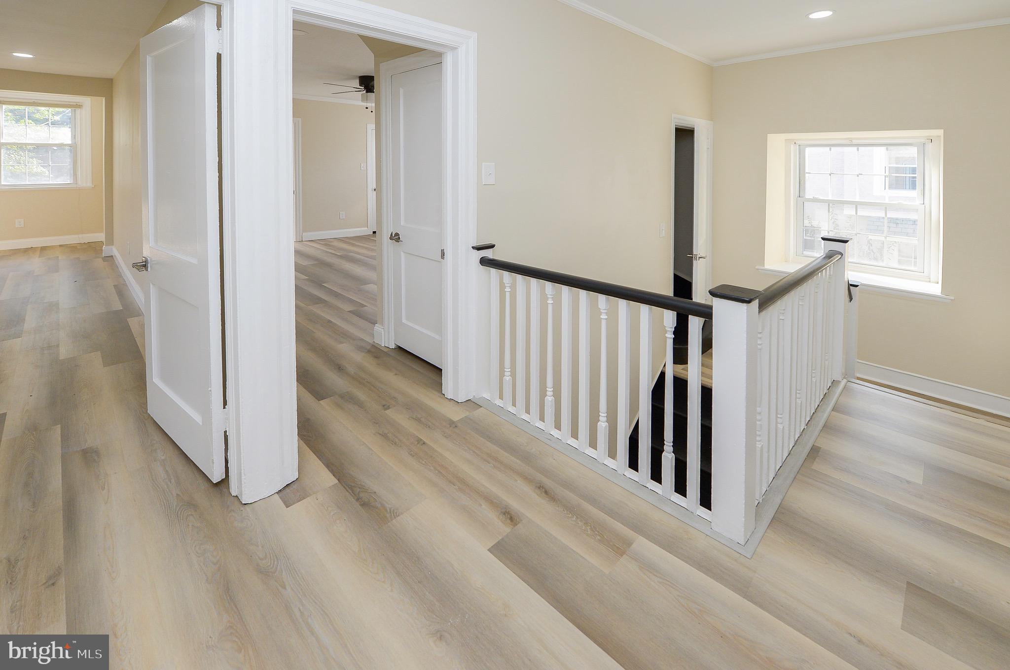 537 Church Road Elkins Park, PA 19027 - Photo 20 of 39 a view of a hallway with wooden floor and staircase