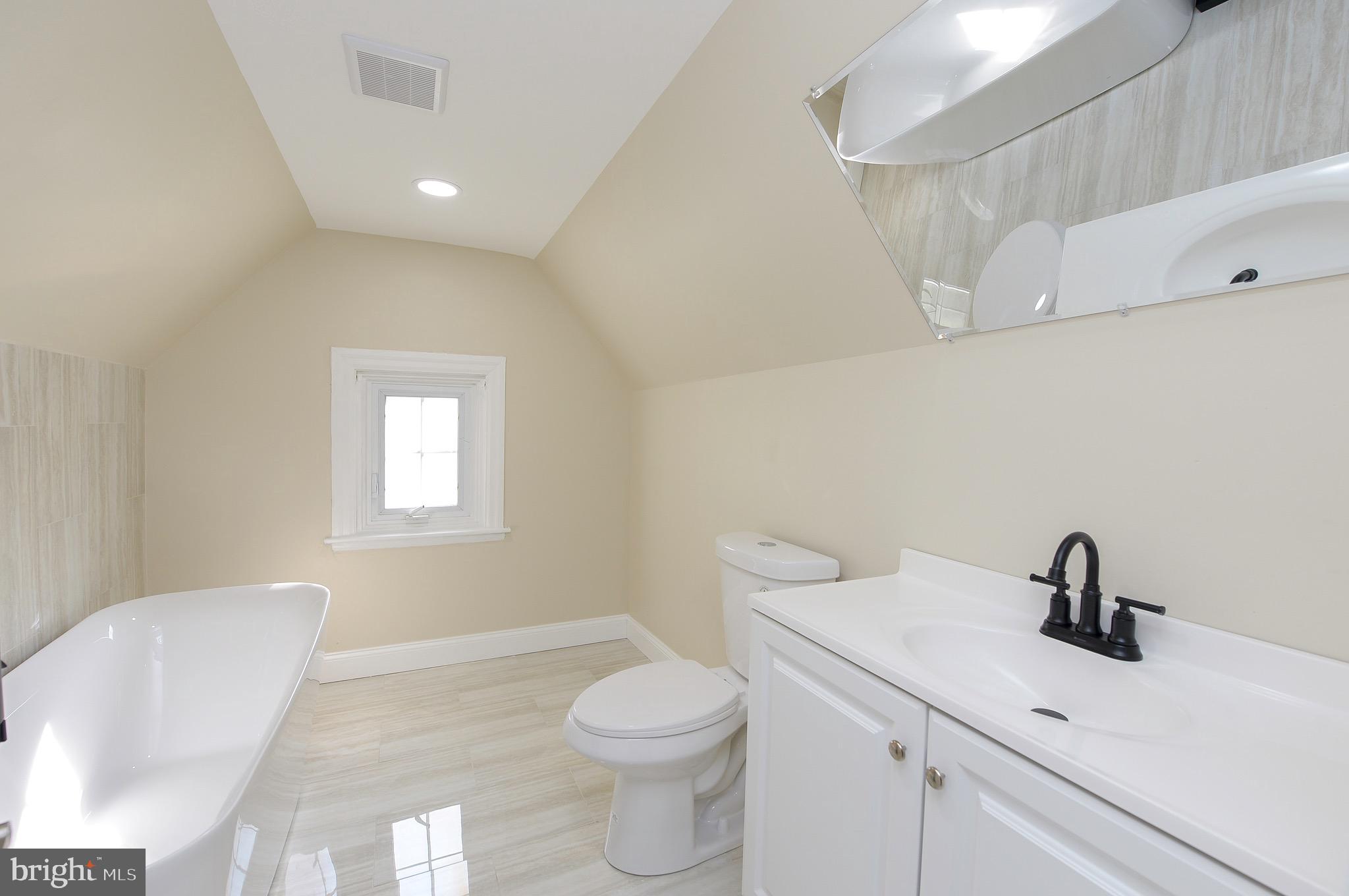 537 Church Road Elkins Park, PA 19027 - Photo 36 of 39 a bathroom with a toilet a sink a mirror and vanity