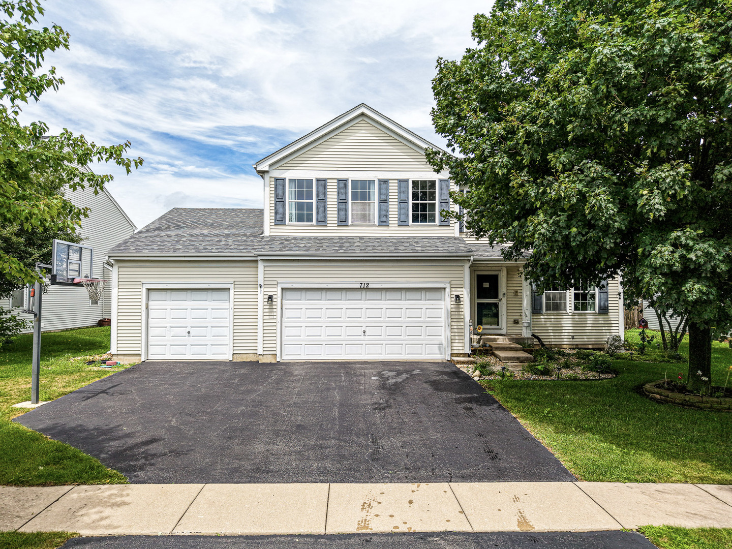 712 Wilson Street Waterman, IL 60556 - Photo 24 of 24 a front view of a house with a yard and garage