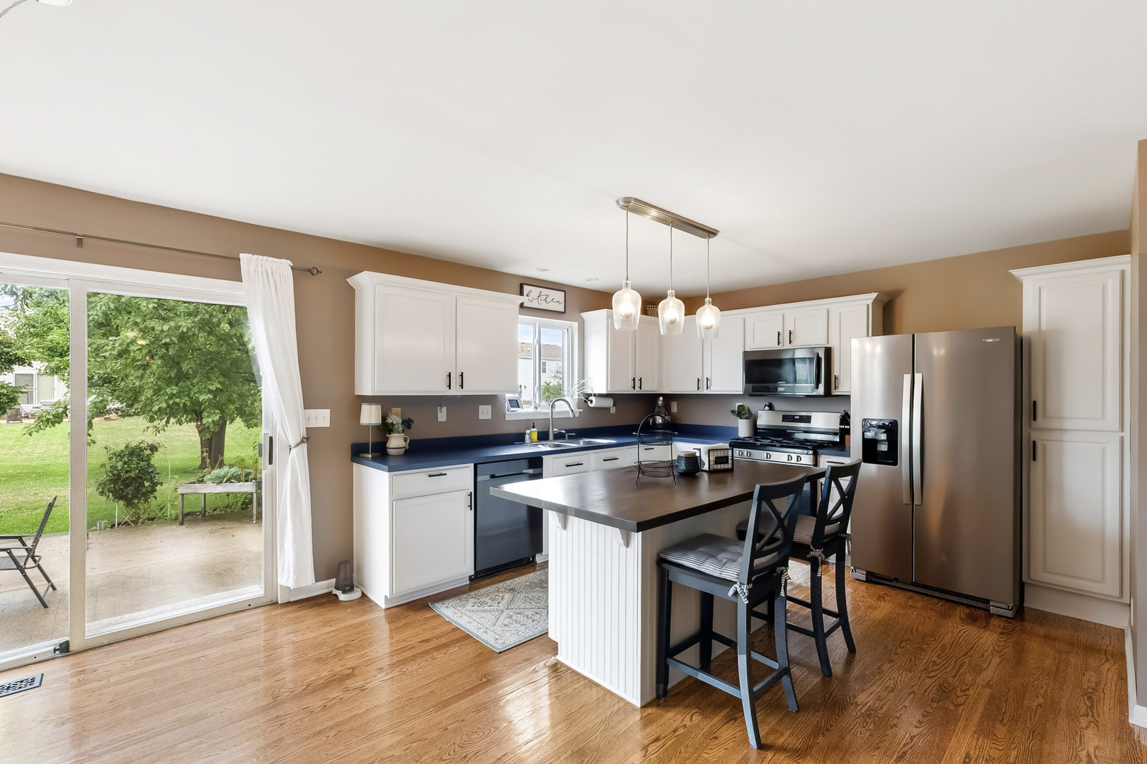 712 Wilson Street Waterman, IL 60556 - Photo 5 of 24 a kitchen with a table chairs refrigerator and microwave