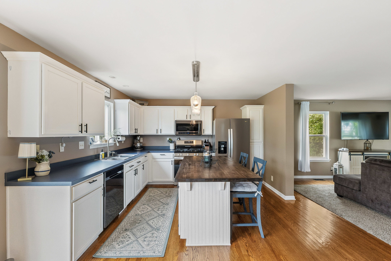 712 Wilson Street Waterman, IL 60556 - Photo 7 of 24 a kitchen with a sink cabinets and wooden floor