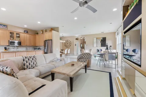 a living room with furniture and a view of kitchen