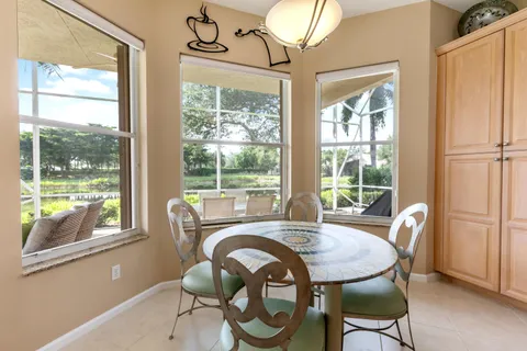 a dining room with furniture a chandelier and wooden floor