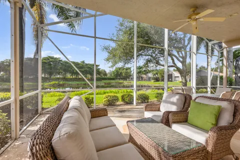 a living room with furniture and a floor to ceiling window