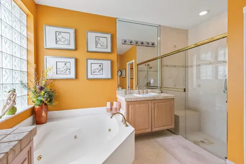 a bathroom with a tub sink and mirror