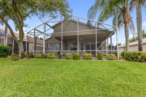 a view of a house with backyard and sitting area